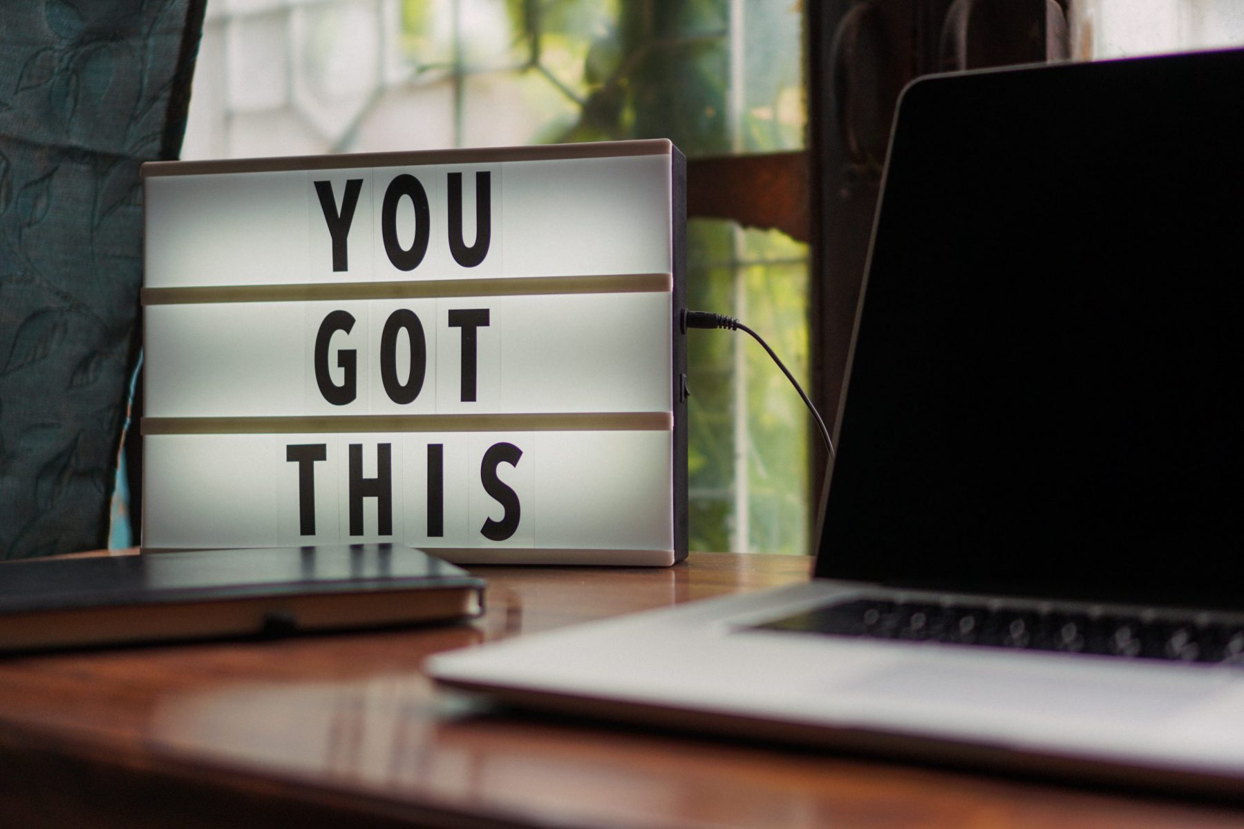 “You Got This” sign on desk with laptop