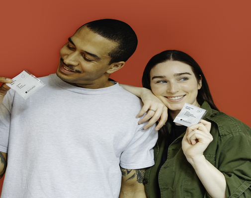 Woman and man smiling while holding Autumn DNA personalized vitamin packets